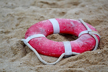 red lifeguard ring on sand thumbnail
