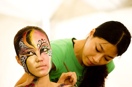 woman in green shirt body painting person thumbnail