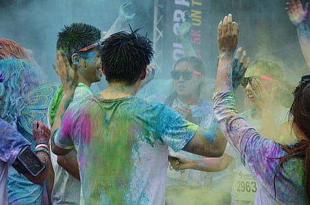 group of people covered with paint and celebrating thumbnail