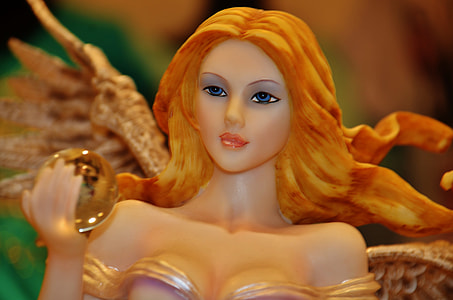 female figurine holding a crystal ball thumbnail