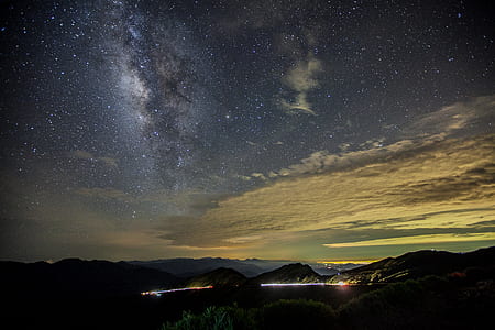 milky way photography of hills at night thumbnail
