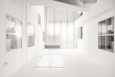 white concrete wall near glass window inside room thumbnail