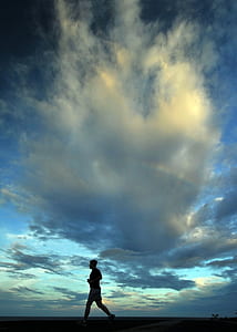 silhouette of a running man during dawn thumbnail
