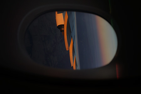 photo of gray airplane flying on cloudy sky during sunset thumbnail