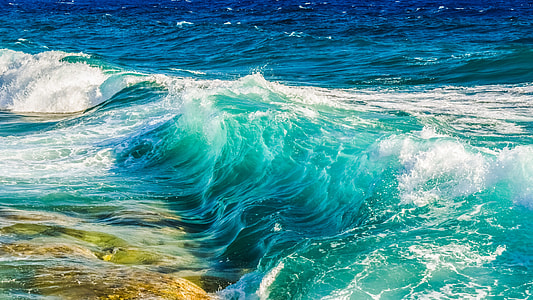 waves rush to shore during daytime thumbnail