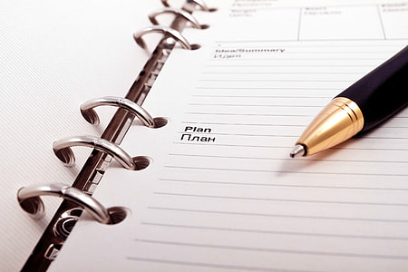 black and brown pen on white notedbook opened thumbnail