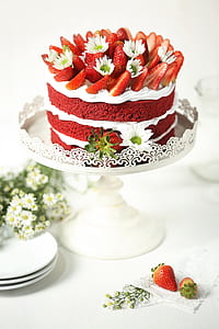 round icing covered cake with sliced strawberry on top thumbnail