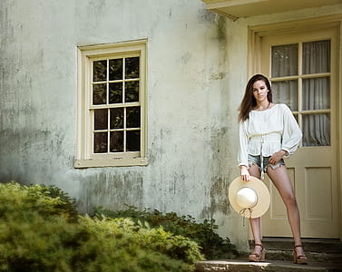 Woman Holding Wide Brim Hat thumbnail