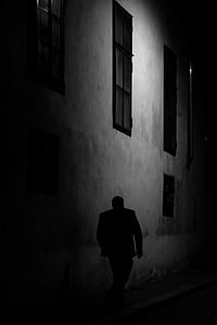 man walking on road beside building thumbnail
