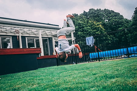 Person in Gray Shirt Doing Trick Under White Clouds and Blue Sky thumbnail