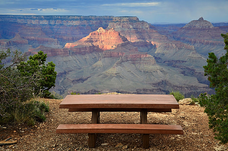 brown and black picnic table with a view of mountain thumbnail