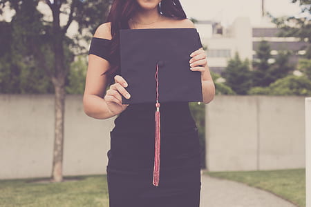 woman holding academic hat at daytime thumbnail
