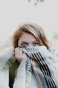 woman covering her face with black and white plaid textile thumbnail