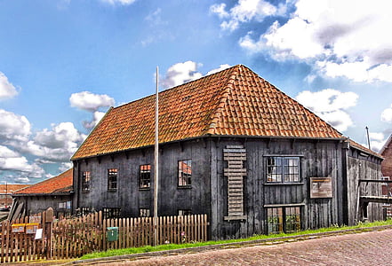 brown and gray wooden house with bricks roof thumbnail