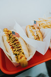 sausage in a bun on top of red tray thumbnail