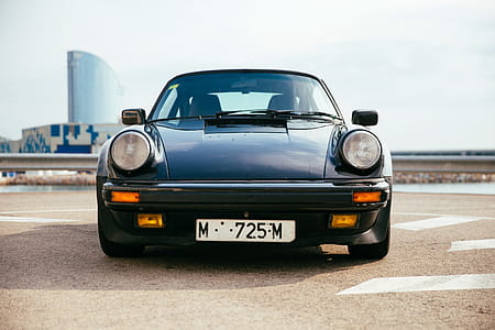 Front view of a black sports car with round head lights thumbnail