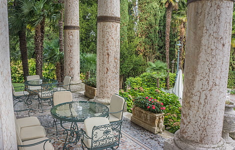patio bistro on floor near concrete pillars thumbnail