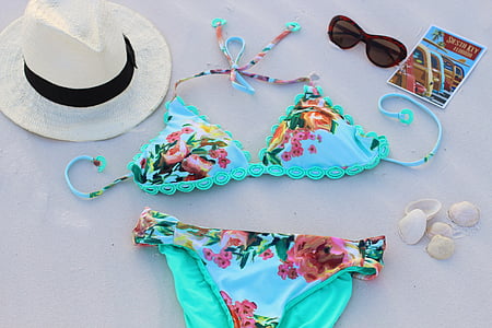 pair of multicolored floral bikini beside white fedora hat thumbnail
