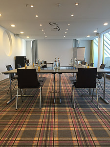 empty conference room with projector canvas and table and chairs setup thumbnail