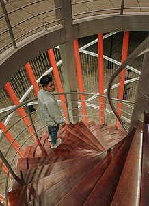 Man Wearing Gray Long-sleeved Top at the Staircase thumbnail
