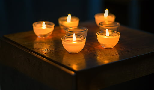 five lighted votive candles thumbnail