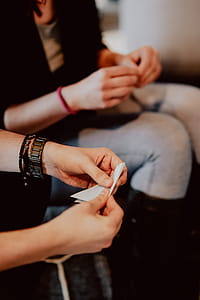 Women folding sheet of paper while making origami thumbnail
