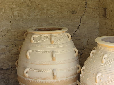 beige floor jar near concrete wall thumbnail