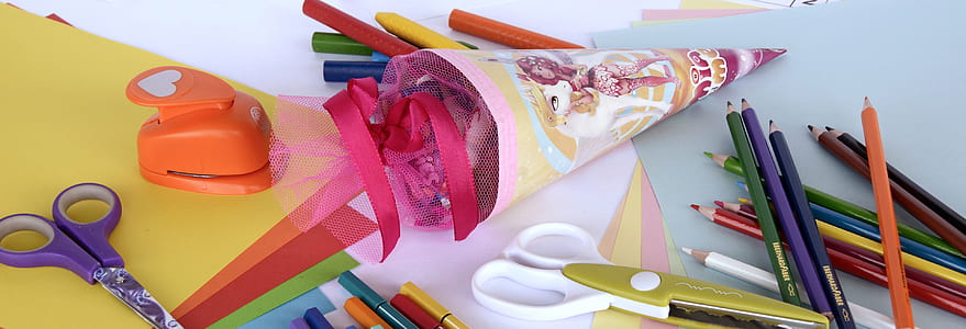 scissors and colored pencils on white surface thumbnail