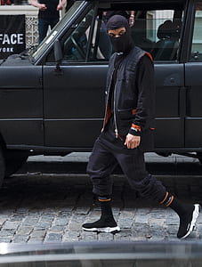 man wearing balaclava beside car thumbnail