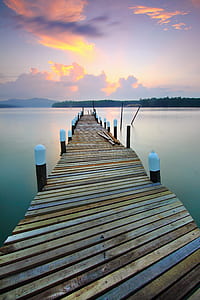 photo of brown wooden dock and body of water thumbnail