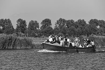 grayscale photography of people riding boat on body of water thumbnail