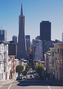 vehicles on road with view of high-rise buildings during daytime photo thumbnail