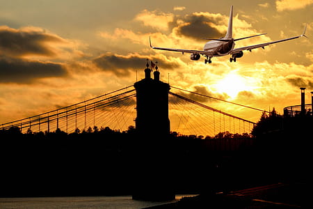 silhouette of bridge under gray airplane thumbnail