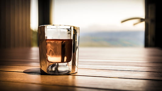 glass of liquid on brown surface thumbnail