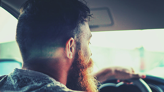 bearded man driving a car thumbnail