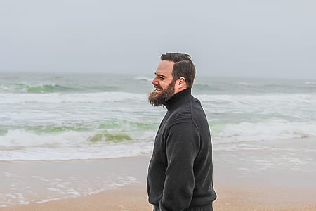 Man in Black Turtle-neck Jacket Standing on Shore thumbnail