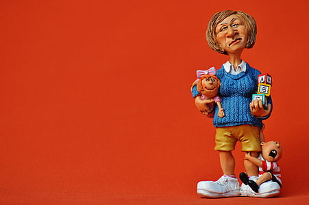 brown haired woman holding baby figurine thumbnail