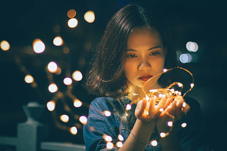 Close-Up Photography of Woman Holding Sting Lights thumbnail