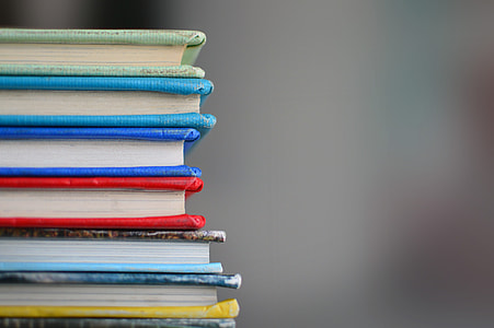 piled assorted-color hardbound books in selective focus photography thumbnail