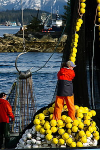 person standing on ship holding yellow rope thumbnail