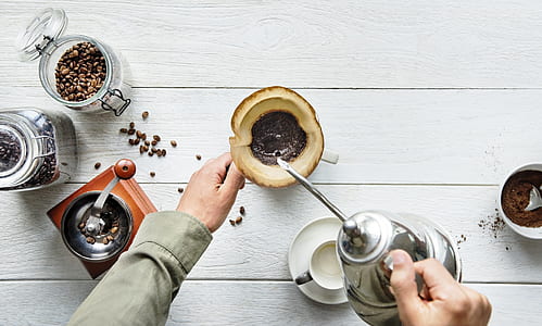 person holding teapot pouring on mug thumbnail