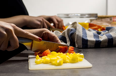 person's hand slicing fruits thumbnail