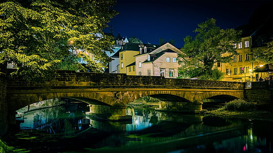brown concrete bridge under night sky thumbnail