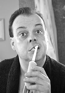 man brushing his teeth in grayscale photography thumbnail