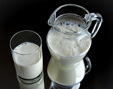 milk in clear glass pitcher and cup thumbnail