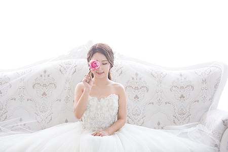 man holding red rose while sitting on sofa thumbnail