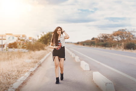 Photography of a Woman Walking on Pavement thumbnail