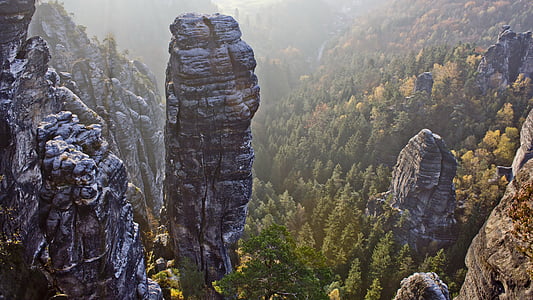 brown mountains beside green trees during daytime thumbnail