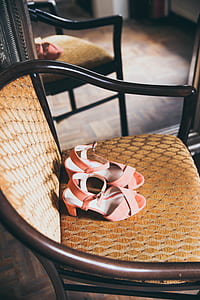pair of brown open-toe heeled sandals on chair thumbnail