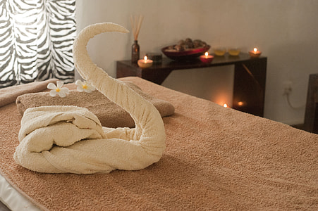 white swan towel on bed thumbnail